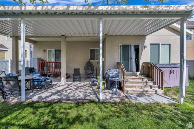 Back of house featuring a lawn, stucco siding, and a patio area | Image 27