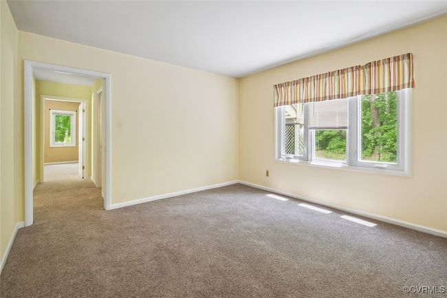 Carpeted empty room featuring baseboards | Image 20