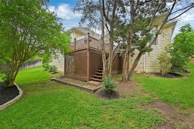 View of yard with fence, a wooden deck, and stairs | Image 23