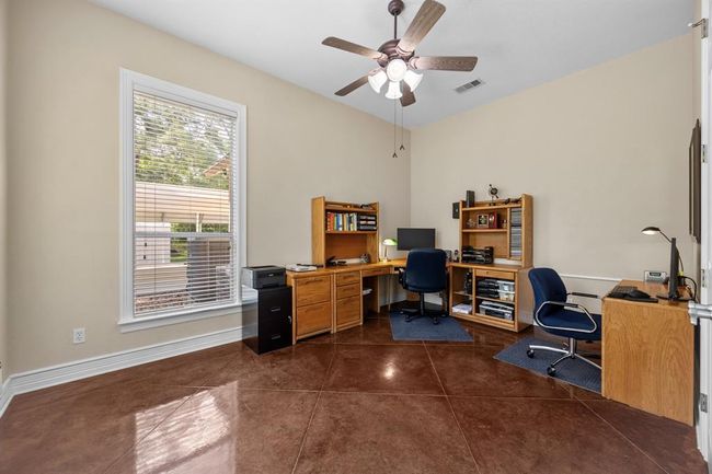 Polished stained-concrete floors and high ceilings create an inspiring workspace with serene yard vistas. | Image 7