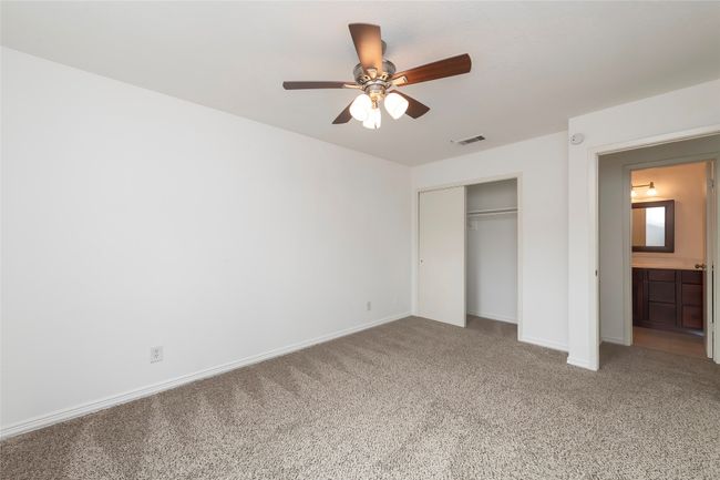 Unfurnished bedroom with visible vents, baseboards, a closet, ceiling fan, and light carpet | Image 15