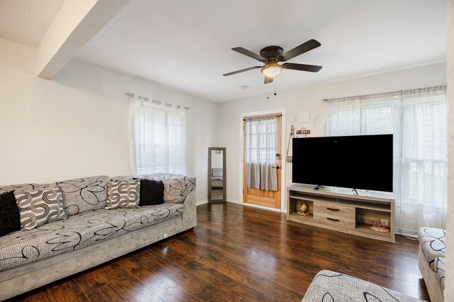 Living area with hardwood / wood-style floors, ceiling fan, and baseboards | Image 6