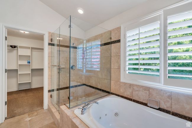 Full bathroom with a shower stall, a tub with jets, a spacious closet, and tile patterned floors | Image 23