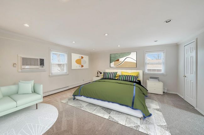 Virtually Staged w/Furniture for concept of size. This bedroom with baseboard heating, ornamental molding, and a wall mounted air conditioner | Image 18