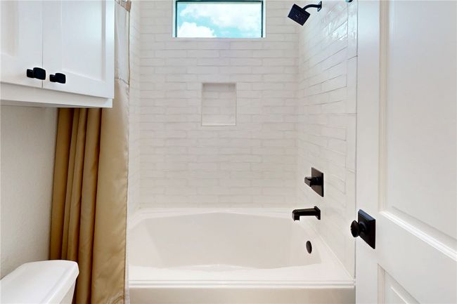 Bathroom featuring toilet and shower / washtub combination | Image 25