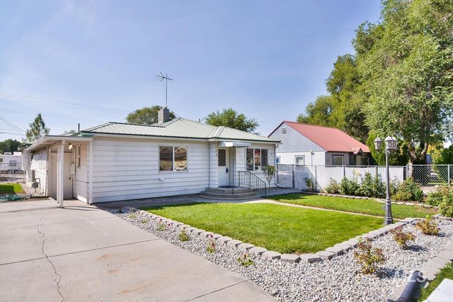 Single story home featuring a metal roof and a chimney | Image 7
