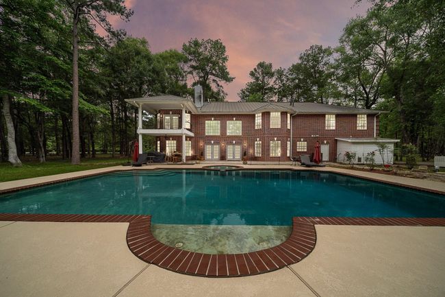View of the home with a large pool and patio | Image 40
