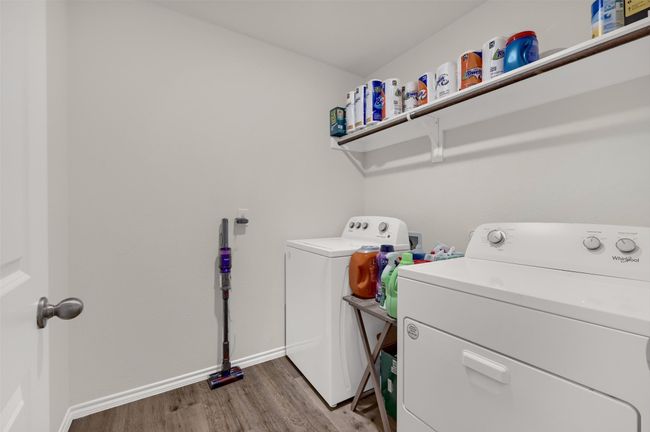 Laundry area with washing machine and dryer and wood finished floors | Image 15