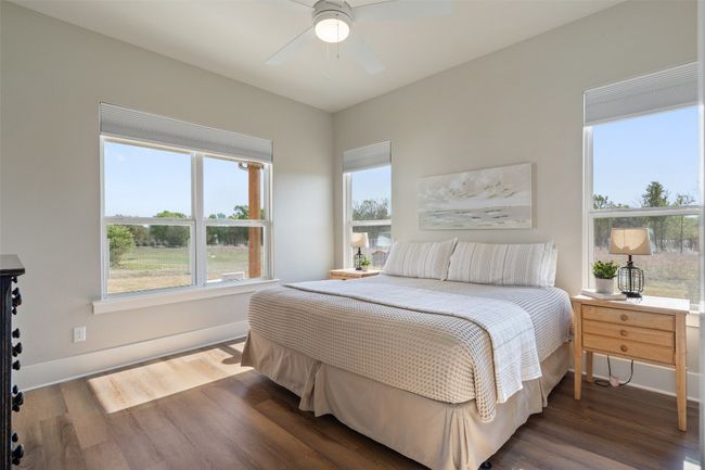 Bedroom with wood finished floors, baseboards, and ceiling fan | Image 13