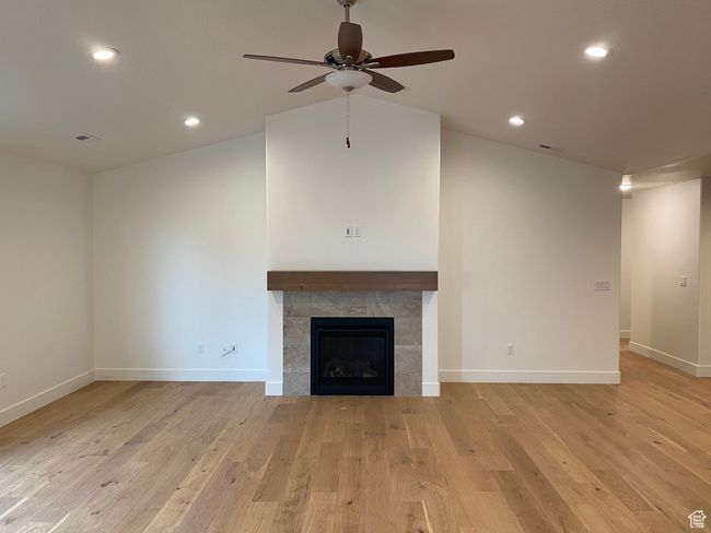Unfurnished living room with light wood-style flooring, visible vents, a ceiling fan, and baseboards | Image 13