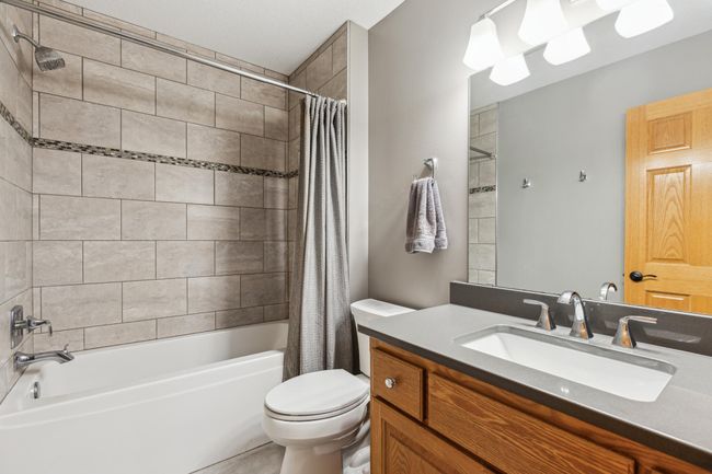 Full custom tiled upper level guest bath | Image 22
