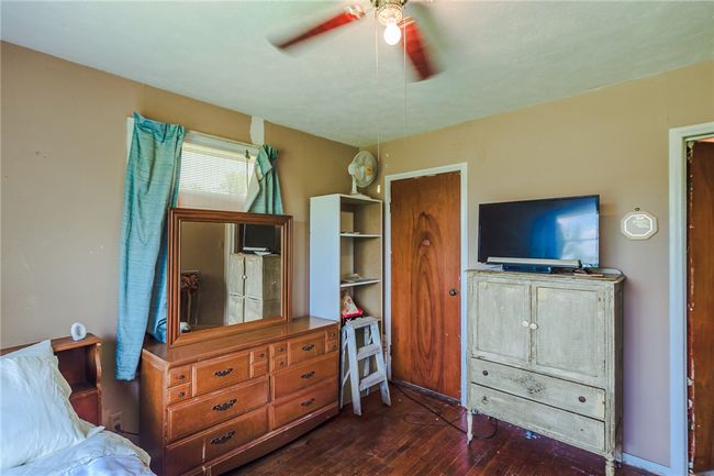 Bedroom with dark wood finished floors and a ceiling fan | Image 23