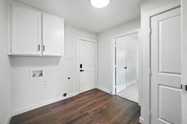 Laundry Room has vabinets above washer, built in cabinets on one wall and a utility closet. | Image 11