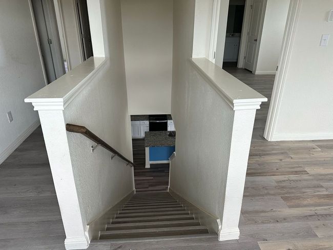 Staircase featuring wood finished floors and a textured wall | Image 13