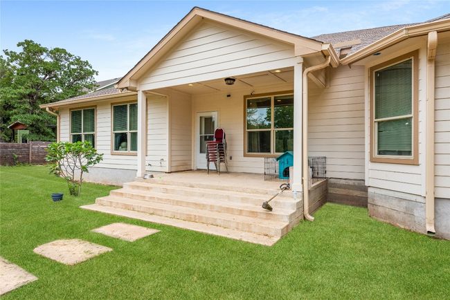 Back of property featuring a shingled roof and covered porch | Image 8