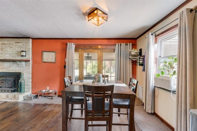 Dining room with wood-type flooring, baseboards, crown molding, and a healthy amount of sunlight | Image 13
