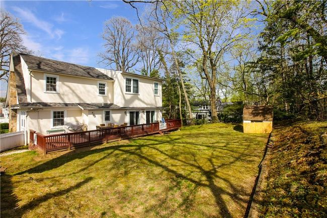 View of the pretty property and large deck. | Image 18