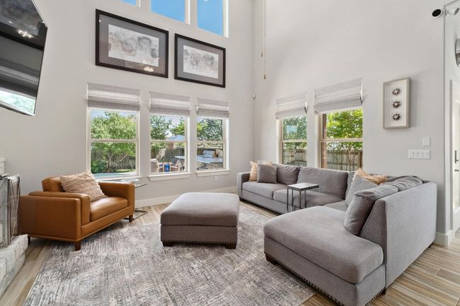 Living area featuring light wood-type tile flooring. | Image 4
