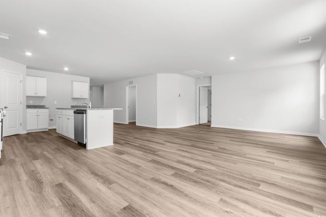 Kitchen with white cabinetry, dishwasher, a kitchen island with sink, and light wood-type flooring | Image 17