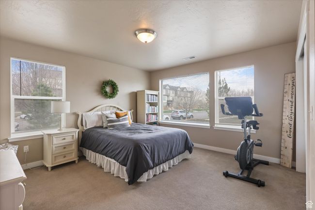 Bedroom featuring light carpet, visible vents, and baseboards | Image 22