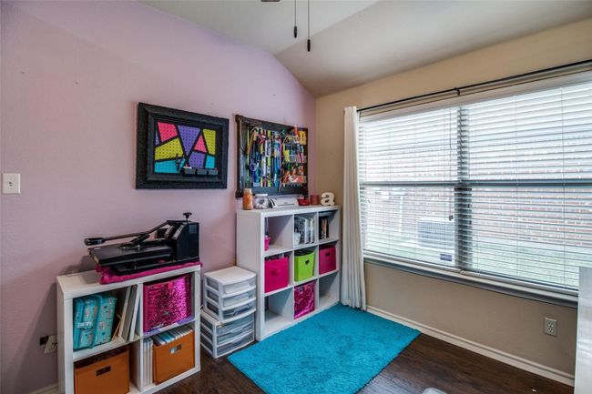 Recreation room with vaulted ceiling, wood finished floors, baseboards, and ceiling fan | Image 15
