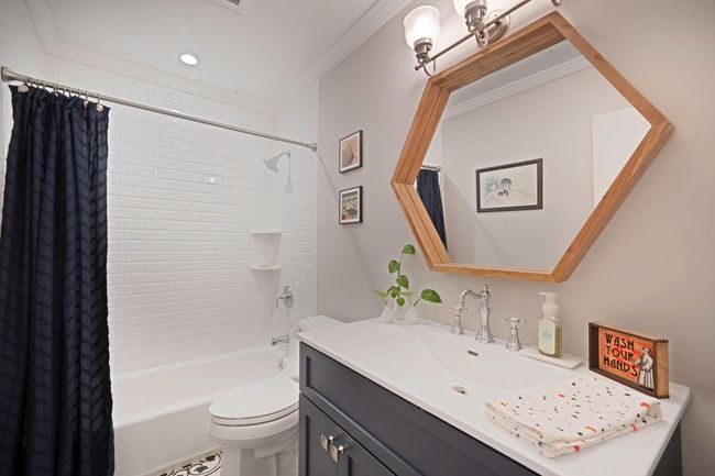 Full bath with vanity, shower / tub combo with curtain, toilet, and crown molding | Image 12