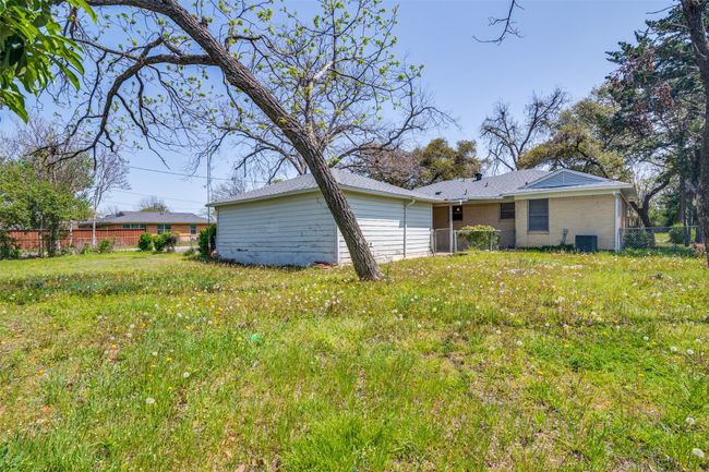 Rear view of property with fence and central air condition unit | Image 25
