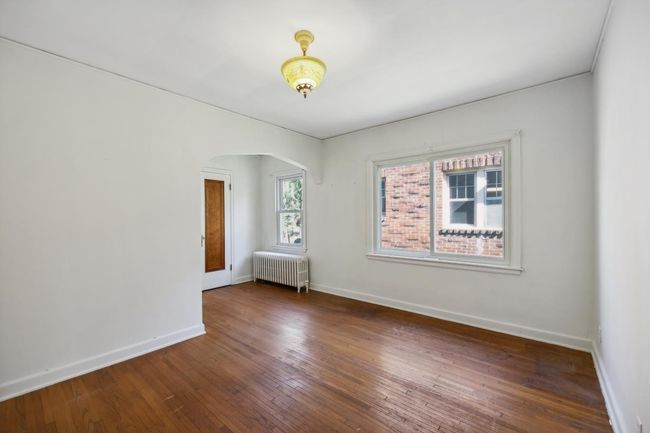 Primary bedroom on the main floor. Two windows to let in a great amount of natural light. | Image 11