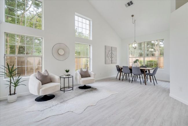 Sitting room featuring high vaulted ceiling, baseboards, and wood finished floors | Image 6