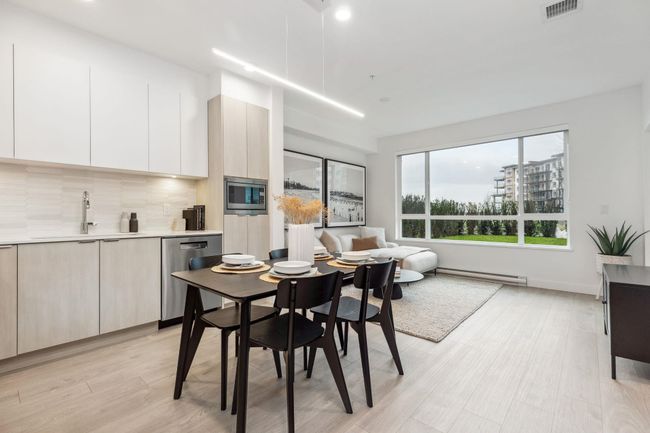 Dining room with a baseboard heating unit, visible vents, recessed lighting, and light wood-type flooring | Image 4