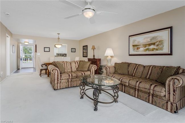 Carpeted living room featuring ceiling fan | Image 5
