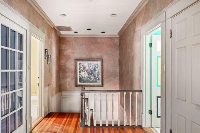 Foyer with wood finished floors, ornamental molding, and wainscoting | Image 16