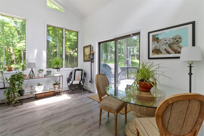 Dining space with wood finished floors and high vaulted ceiling | Image 4