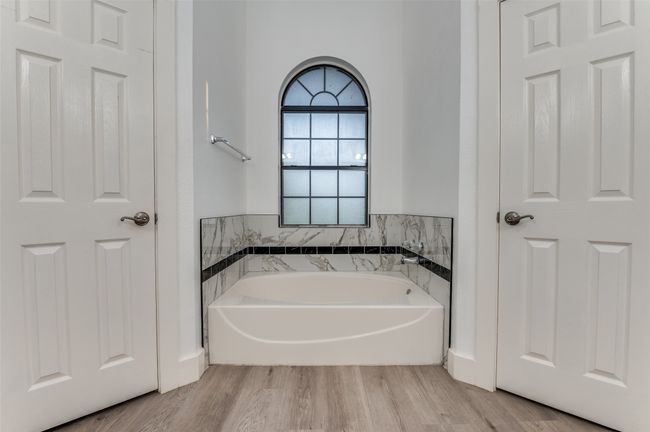 Bathroom with a bath and wood finished floors | Image 20