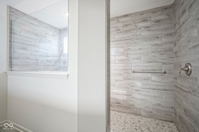 bathroom featuring a tile shower | Image 39