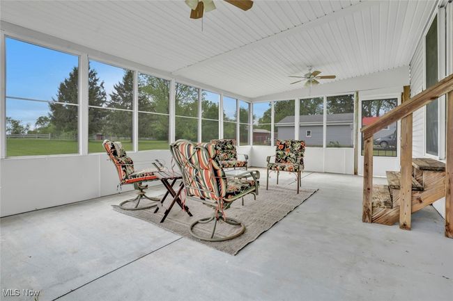 Sunroom / solarium with a ceiling fan | Image 23