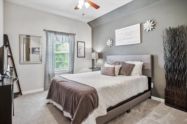 Carpeted bedroom with baseboards, lofted ceiling, and a ceiling fan | Image 20