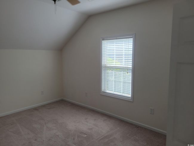 Additional living space with a ceiling fan, carpet floors, and vaulted ceiling | Image 39