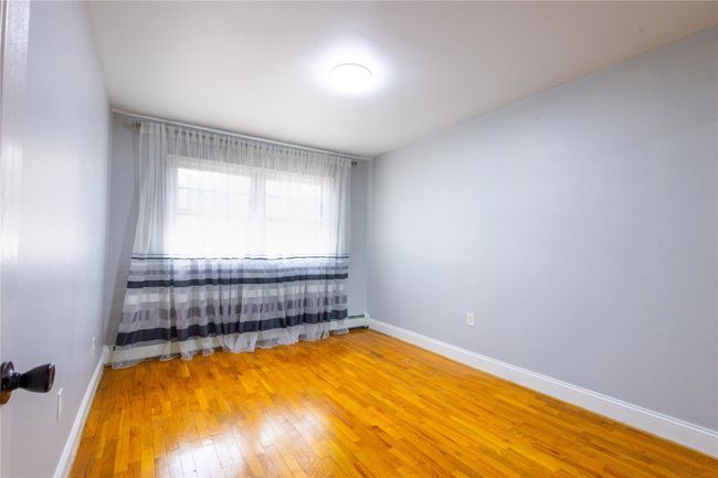 Empty room with light wood finished floors and baseboards | Image 19