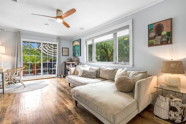 Living room featuring crown molding, healthy amount of natural light, a ceiling fan, and wood finished floors | Image 27