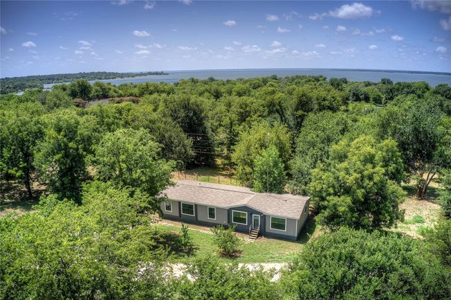 Aerial view of property and surrounding area with a forest and a large body of water | Image 28