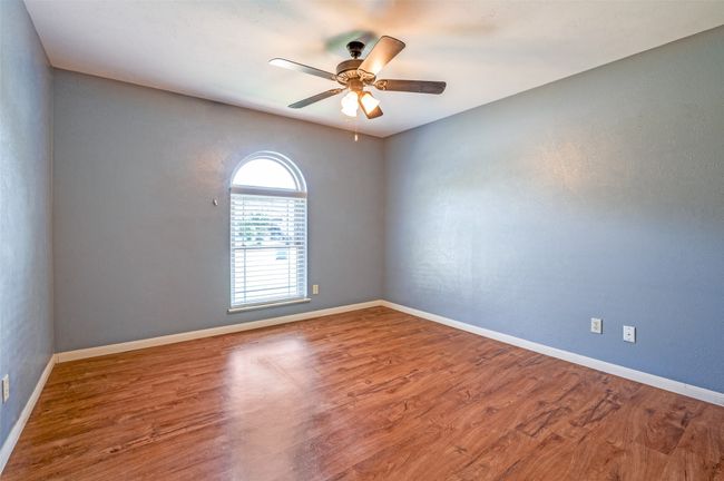 Empty room featuring a ceiling fan and wood finished floors | Image 14