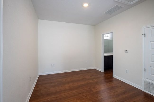 Unfurnished room featuring dark wood-type flooring, baseboards, and visible vents | Image 29