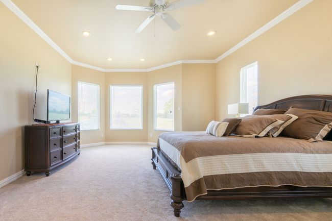 Bedroom featuring recessed lighting, ornamental molding, light colored carpet, and ceiling fan | Image 21