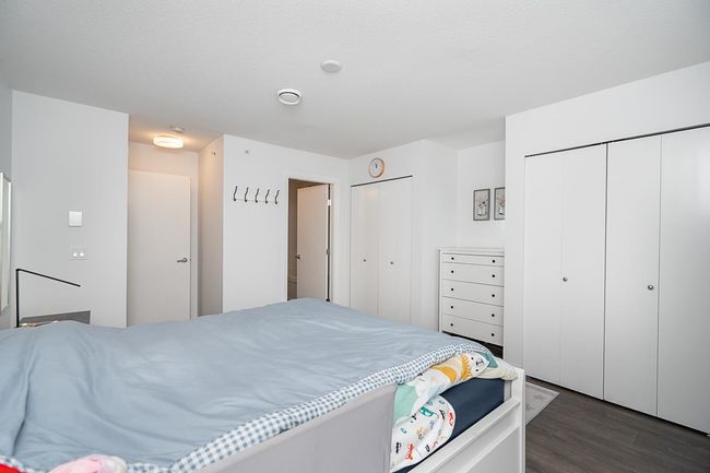 Bedroom featuring dark wood finished floors and multiple closets | Image 19