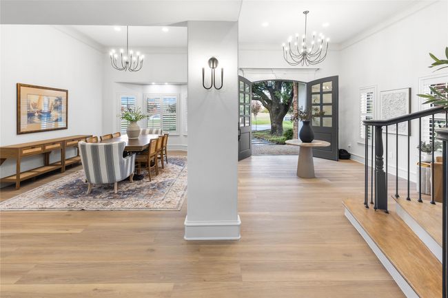Dining room featuring a chandelier, ornamental molding, light wood-style flooring, a towering ceiling, and recessed lighting | Image 5