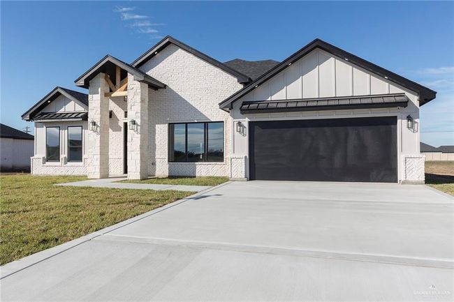 View of front of property featuring a garage and a front lawn | Image 25