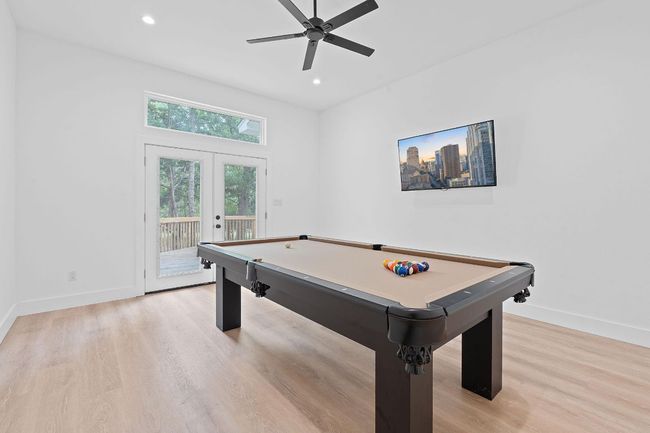 Game room with billiards, fan, baseboards, french doors, and light wood type floors | Image 17