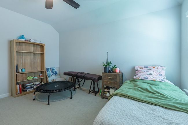 Carpeted bedroom featuring lofted ceiling and a ceiling fan | Image 25