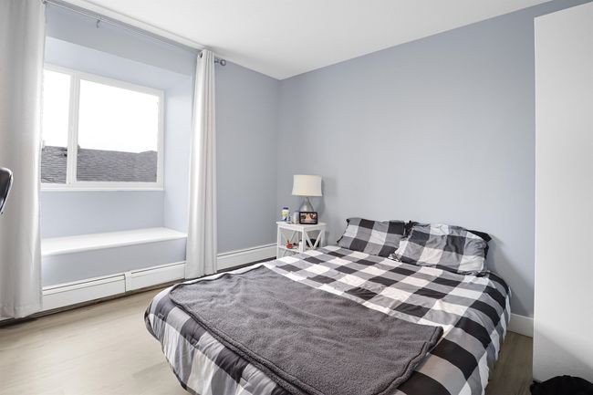 Bedroom featuring baseboards, baseboard heating, and wood finished floors | Image 24